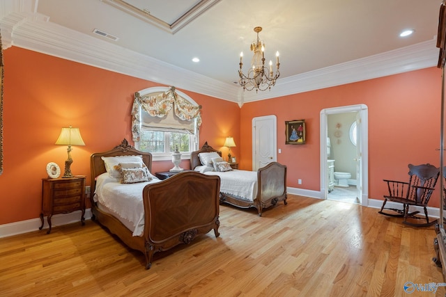 bedroom with light wood-type flooring, ornamental molding, ensuite bathroom, and a notable chandelier