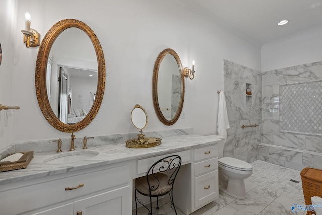 bathroom featuring vanity, a tile shower, and toilet