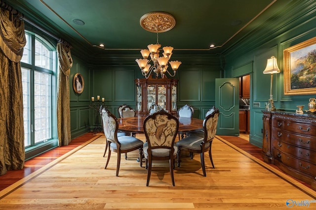 dining area featuring an inviting chandelier, crown molding, and plenty of natural light