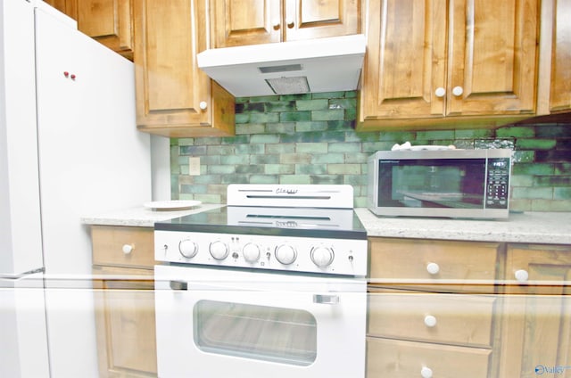 kitchen featuring light stone counters, white appliances, exhaust hood, and decorative backsplash