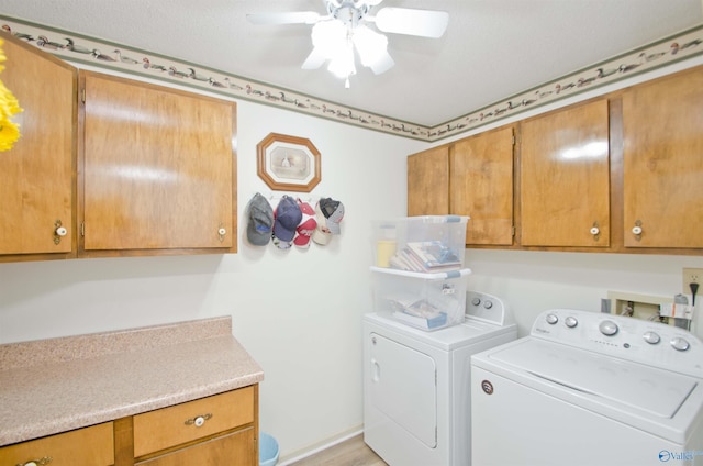 clothes washing area featuring cabinets, washing machine and dryer, and ceiling fan