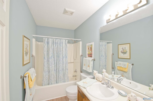 full bathroom featuring vanity, shower / tub combo, a textured ceiling, and toilet