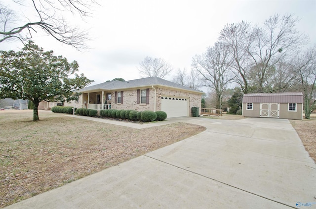 single story home with a porch, a garage, and a storage unit