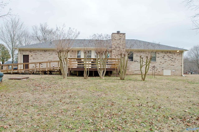 back of property featuring a lawn and a deck