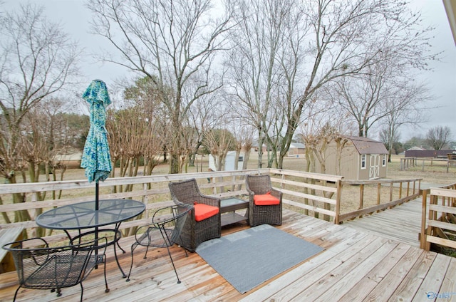 wooden terrace featuring a storage unit