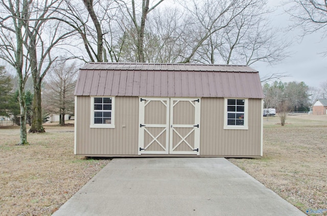 view of outdoor structure with a lawn