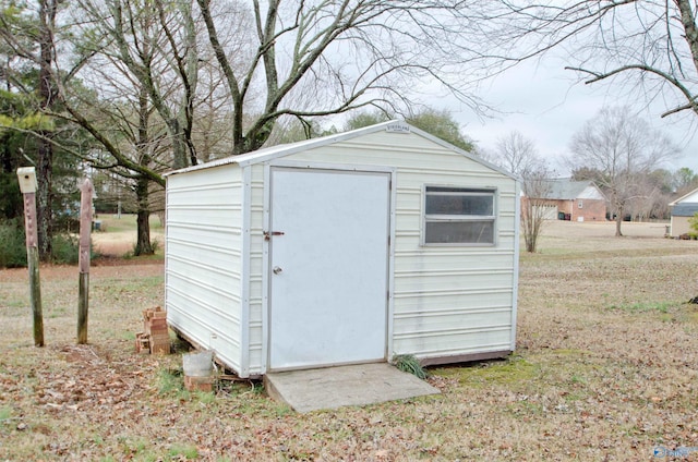 view of outbuilding featuring a lawn