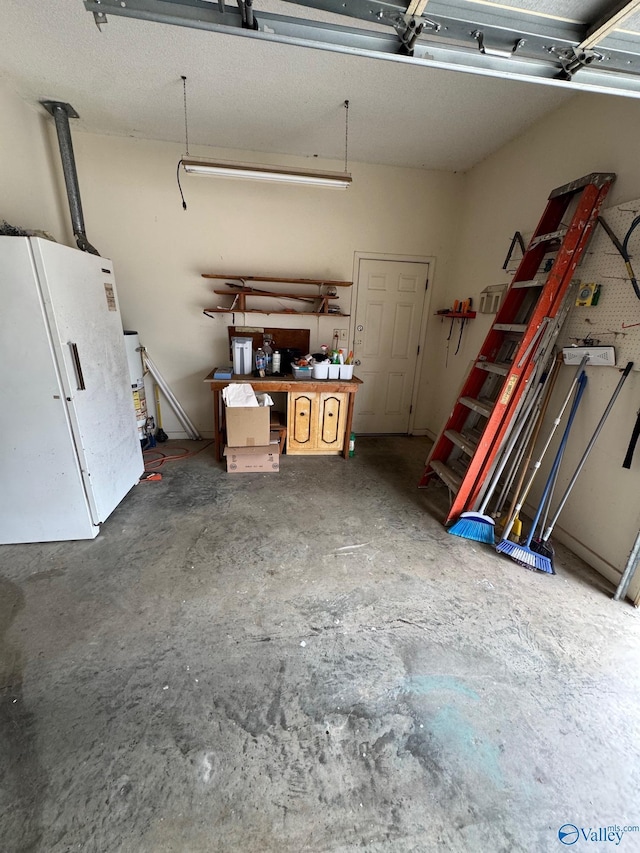 garage with white refrigerator and a workshop area