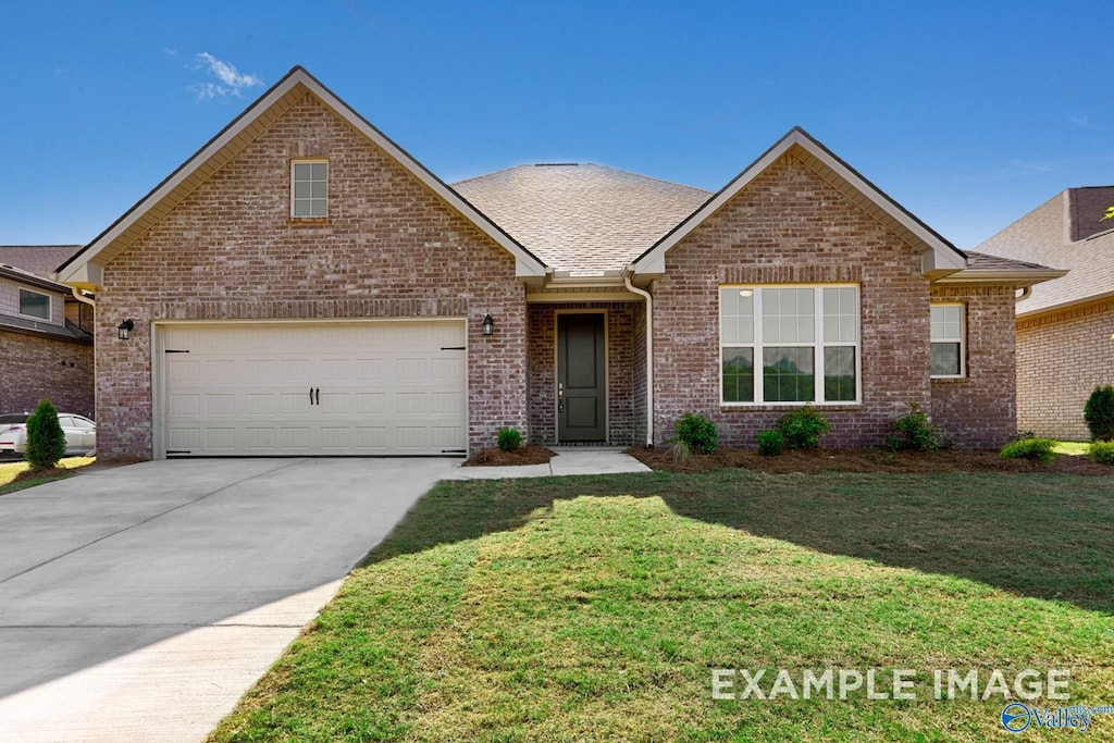 front facade with a front yard and a garage