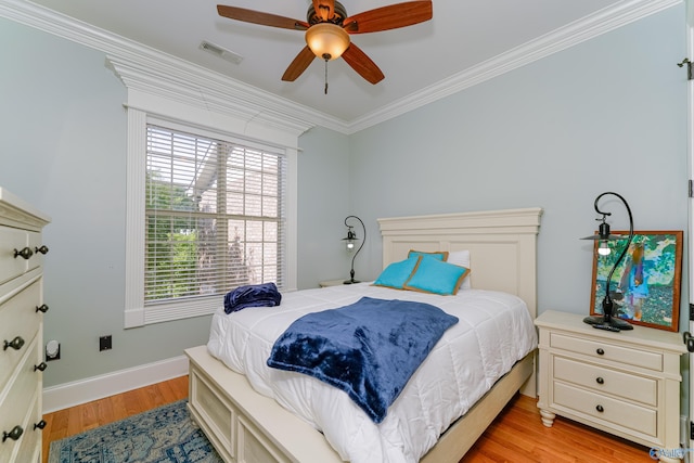 bedroom featuring crown molding, ceiling fan, and light hardwood / wood-style flooring