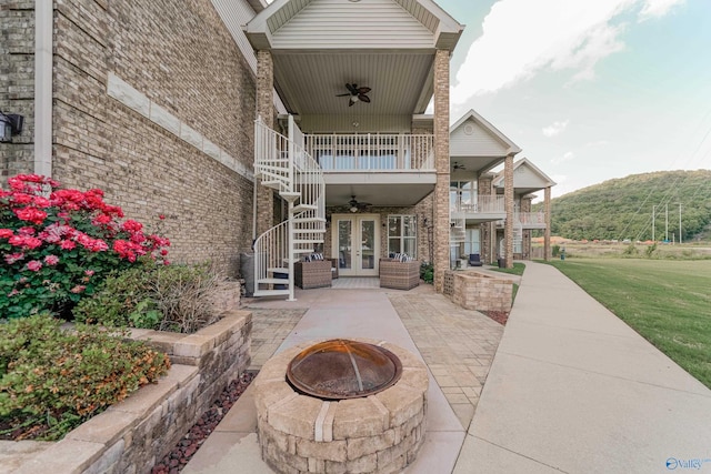 exterior space featuring a mountain view and an outdoor fire pit