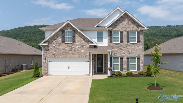 9130 Monteagle Blvd, Owens Cross Roads, AL 35763 - view of front of home featuring concrete driveway, a front lawn, brick siding, central AC unit, and a garage