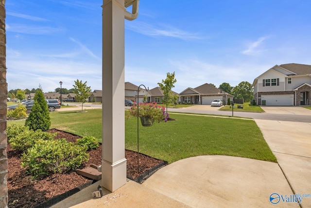 9130 Monteagle Blvd, Owens Cross Roads, AL 35763 - view of grassy yard with a residential view, driveway, and a garage