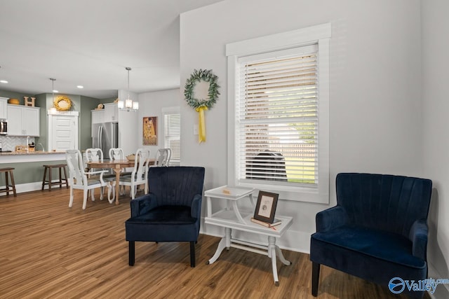9130 Monteagle Blvd, Owens Cross Roads, AL 35763 - sitting room featuring light wood-type flooring, a chandelier, and plenty of natural light
