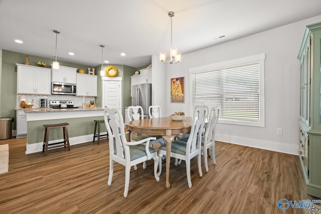 9130 Monteagle Blvd, Owens Cross Roads, AL 35763 - dining space featuring wood finished floors, a chandelier, recessed lighting, and baseboards
