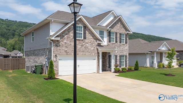 9130 Monteagle Blvd, Owens Cross Roads, AL 35763 - view of front facade with an attached garage, brick siding, concrete driveway, and a shingled roof