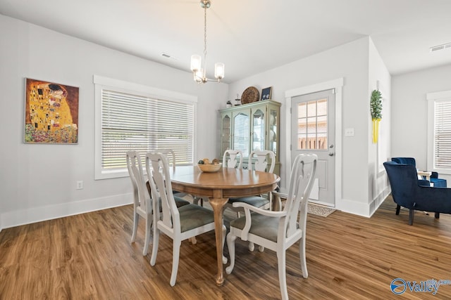 9130 Monteagle Blvd, Owens Cross Roads, AL 35763 - dining area featuring wood finished floors, baseboards, and a chandelier