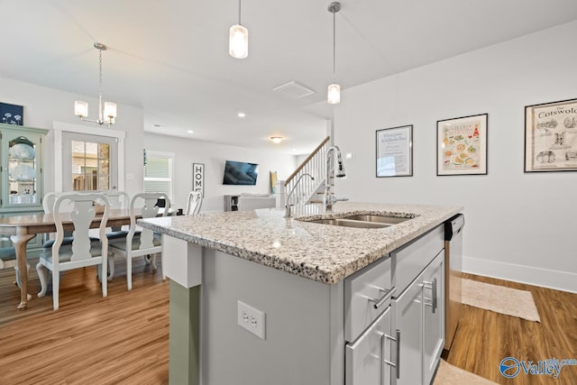 9130 Monteagle Blvd, Owens Cross Roads, AL 35763 - kitchen with a sink, light wood-style floors, baseboards, gray cabinetry, and hanging light fixtures