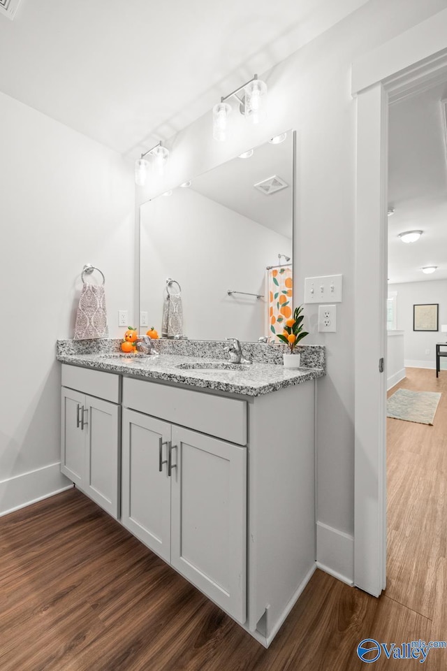 9130 Monteagle Blvd, Owens Cross Roads, AL 35763 - full bathroom with wood finished floors, double vanity, and baseboards
