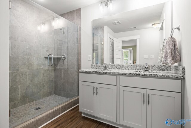 9130 Monteagle Blvd, Owens Cross Roads, AL 35763 - bathroom with wood finished floors, a stall shower, and double vanity