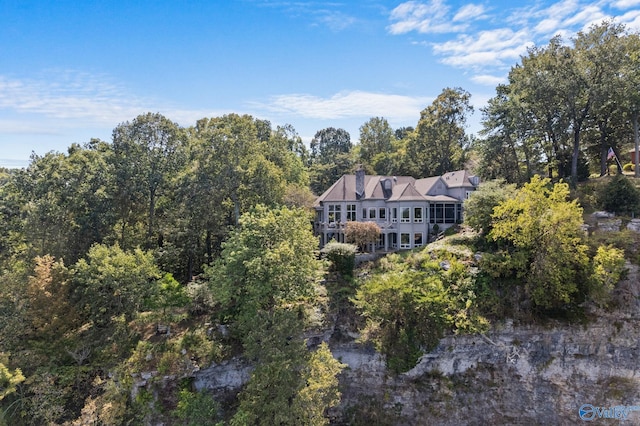 birds eye view of property with a view of trees