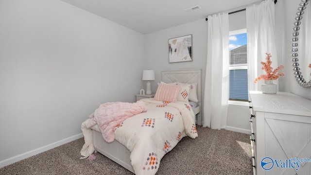 carpeted bedroom featuring visible vents and baseboards