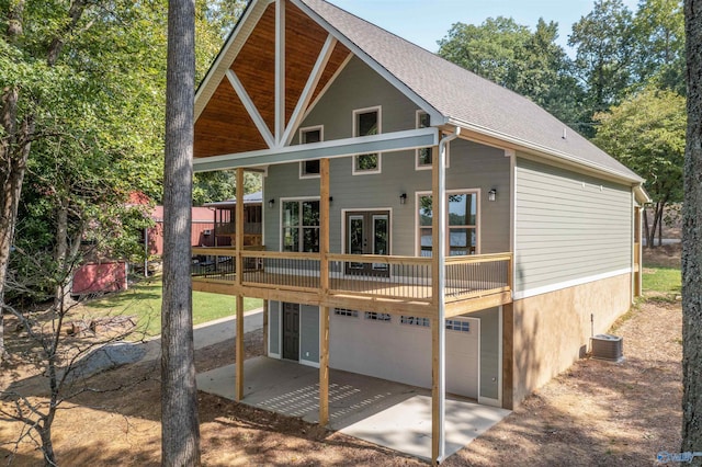 rear view of property with a wooden deck and central air condition unit