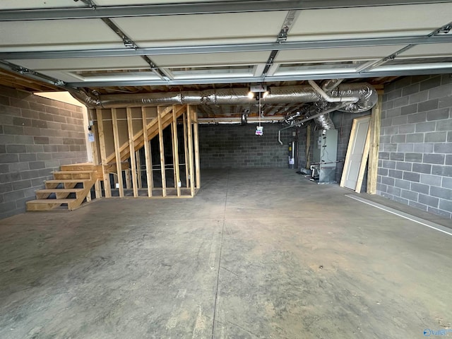 garage featuring water heater and heating unit