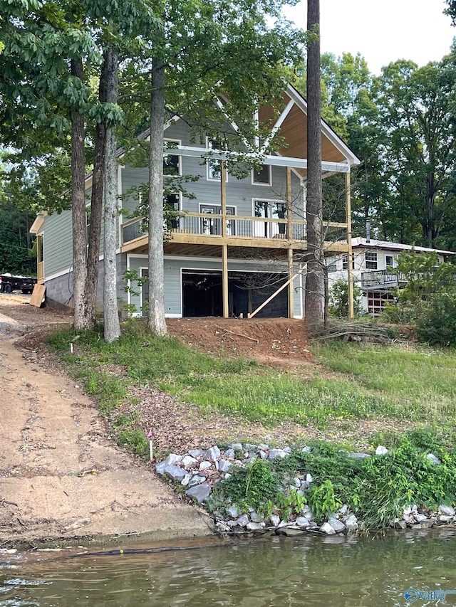 rear view of property with a deck with water view