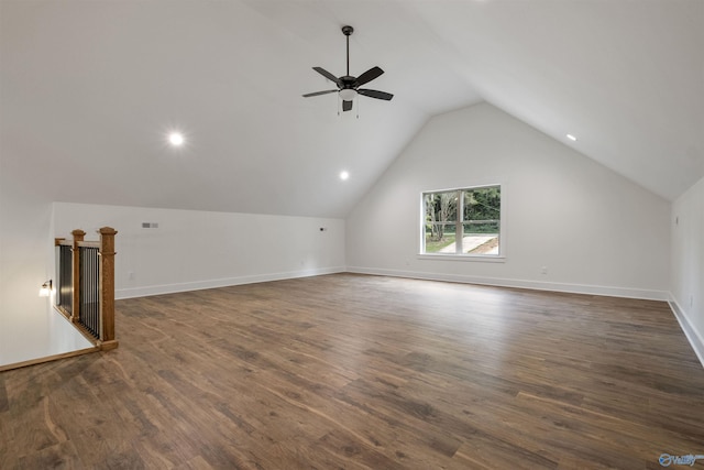 additional living space featuring dark hardwood / wood-style flooring, vaulted ceiling, and ceiling fan