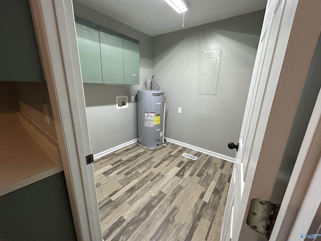 3185 Reeves Rd, Hokes Bluff, AL 35903 - washroom featuring electric water heater, cabinet space, electric panel, light wood-type flooring, and hookup for a washing machine