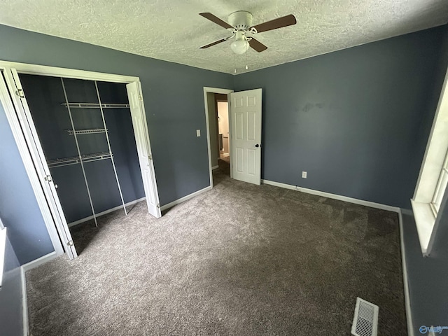 3185 Reeves Rd, Hokes Bluff, AL 35903 - unfurnished bedroom featuring a closet, a textured ceiling, baseboards, carpet floors, and ceiling fan