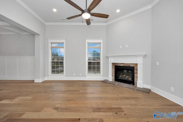 unfurnished living room with crown molding, light hardwood / wood-style flooring, and ceiling fan