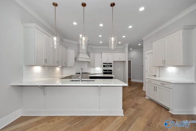 kitchen featuring hanging light fixtures and white cabinetry