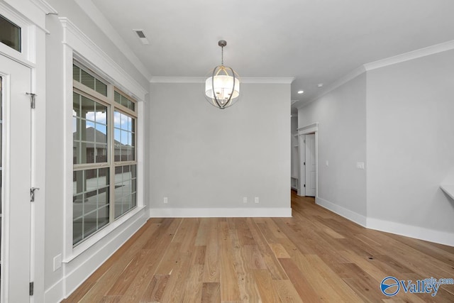 unfurnished dining area with crown molding and light hardwood / wood-style floors