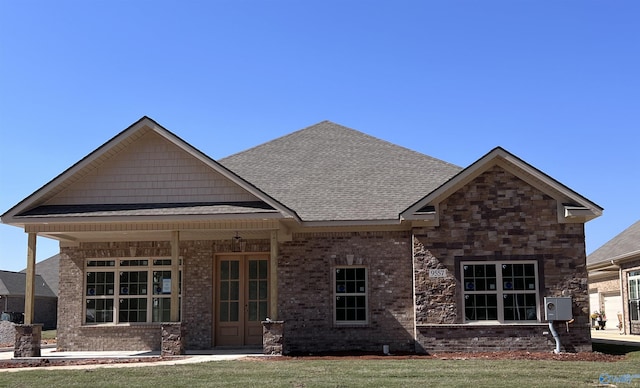 rear view of house featuring a yard