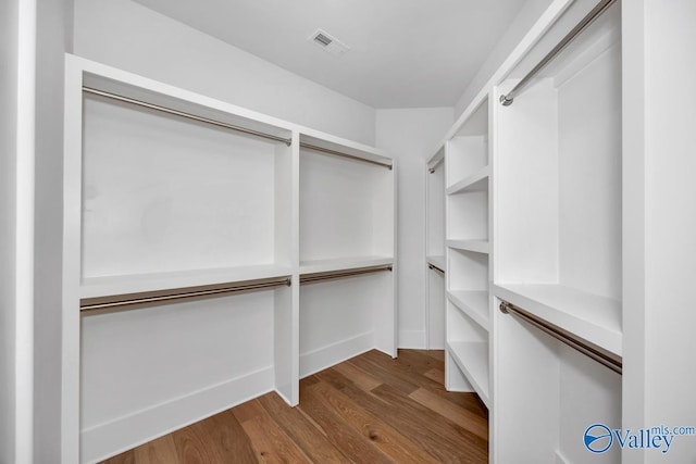 spacious closet featuring hardwood / wood-style flooring