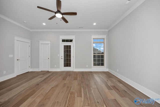 empty room with crown molding, ceiling fan, and light hardwood / wood-style flooring