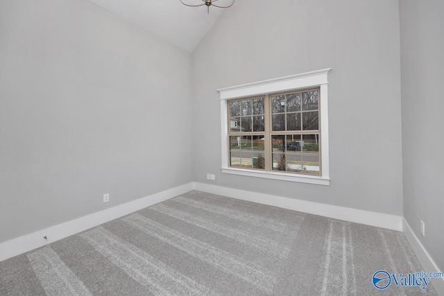 carpeted empty room featuring high vaulted ceiling