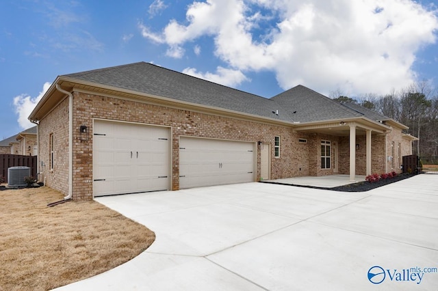 view of front of house with cooling unit and a garage