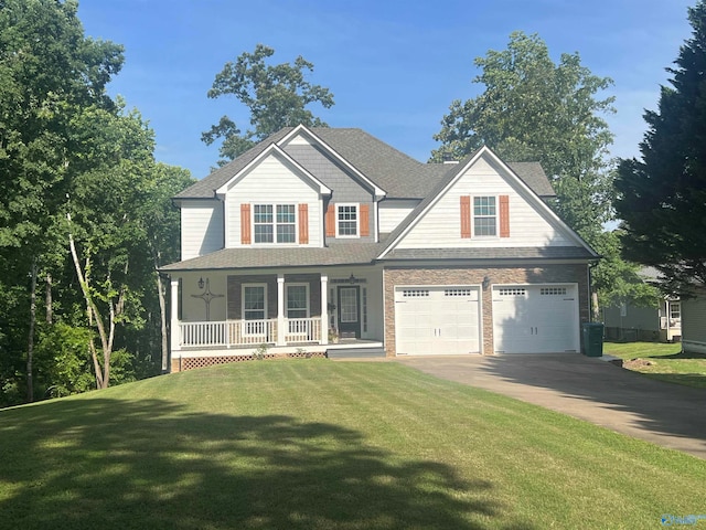 view of front facade with a porch, a garage, and a front yard