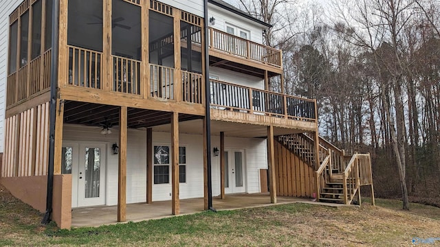 rear view of house with a patio, a wooden deck, and french doors