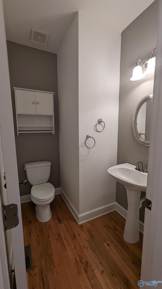 bathroom featuring toilet and hardwood / wood-style floors