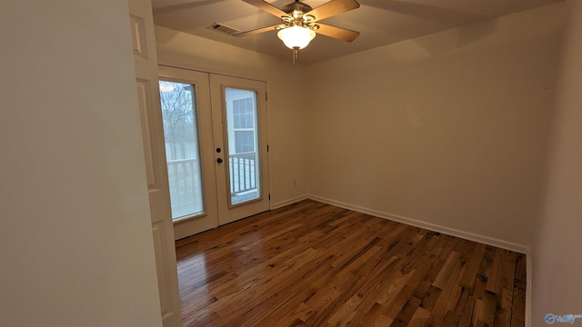 spare room featuring wood-type flooring, french doors, and ceiling fan