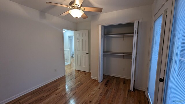 unfurnished bedroom featuring wood-type flooring, a closet, and ceiling fan