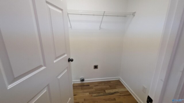 clothes washing area featuring wood-type flooring and electric dryer hookup