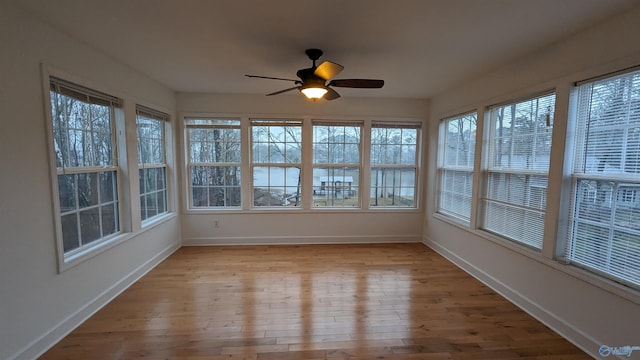 unfurnished sunroom with a healthy amount of sunlight and ceiling fan