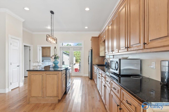 kitchen with pendant lighting, a kitchen island, light hardwood / wood-style flooring, stainless steel appliances, and ornamental molding