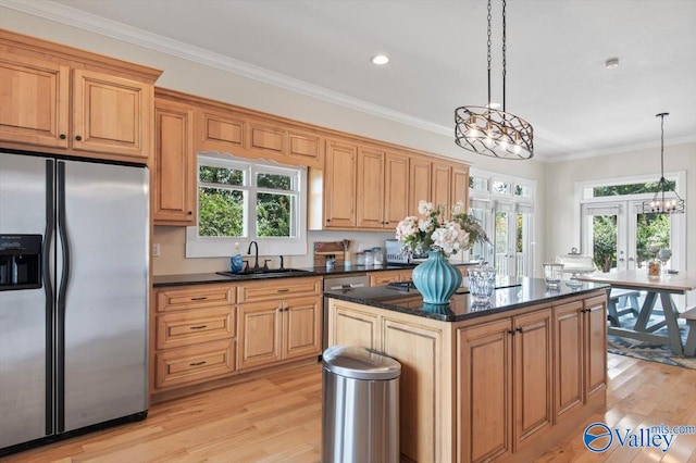 kitchen featuring decorative light fixtures, light wood-type flooring, sink, and stainless steel fridge with ice dispenser