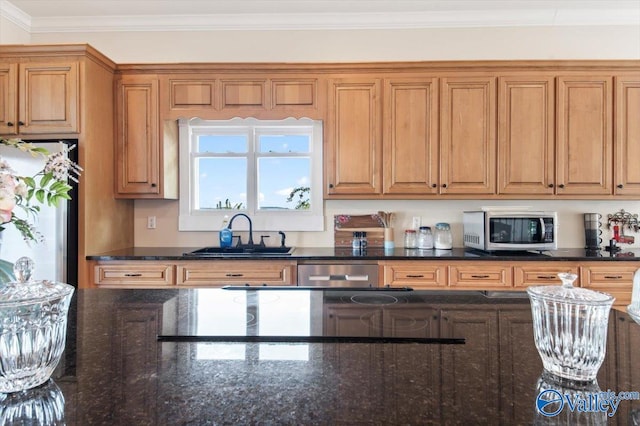 kitchen with dark stone countertops, ornamental molding, stainless steel appliances, and sink